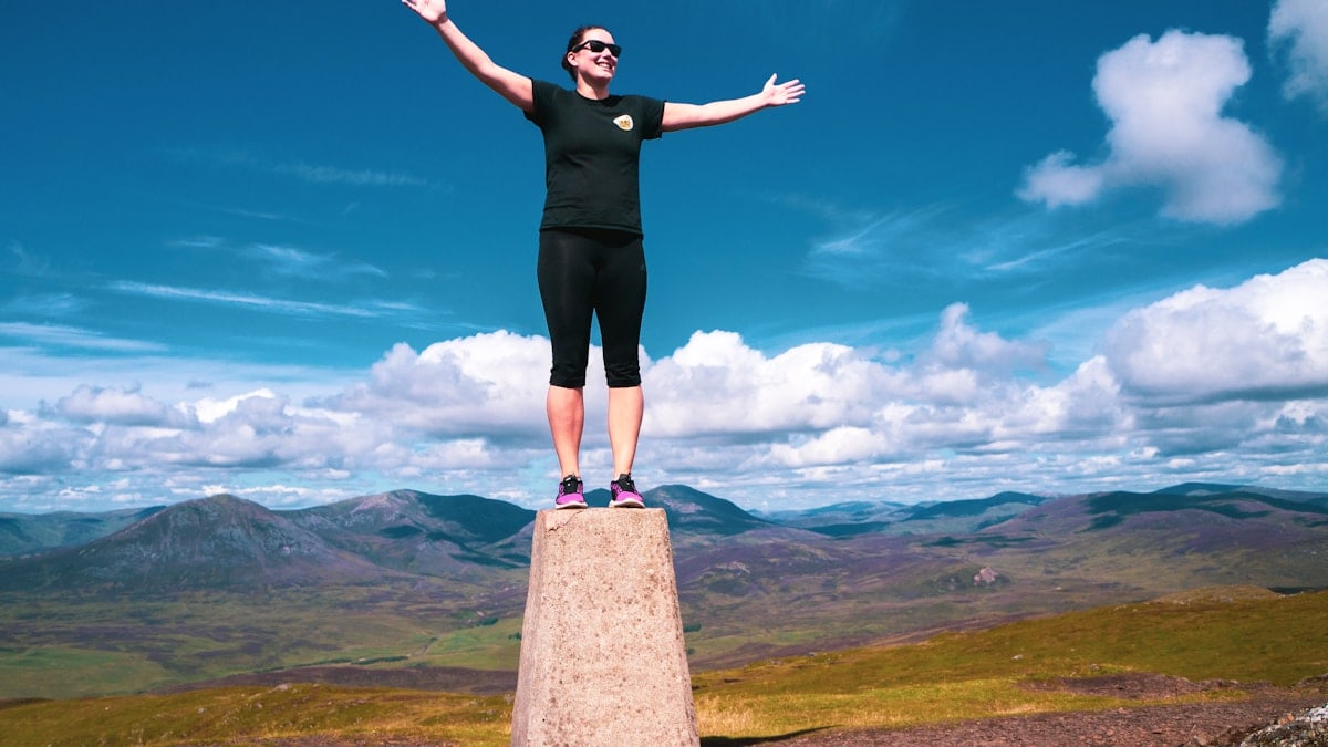 hill climber celebrating peak